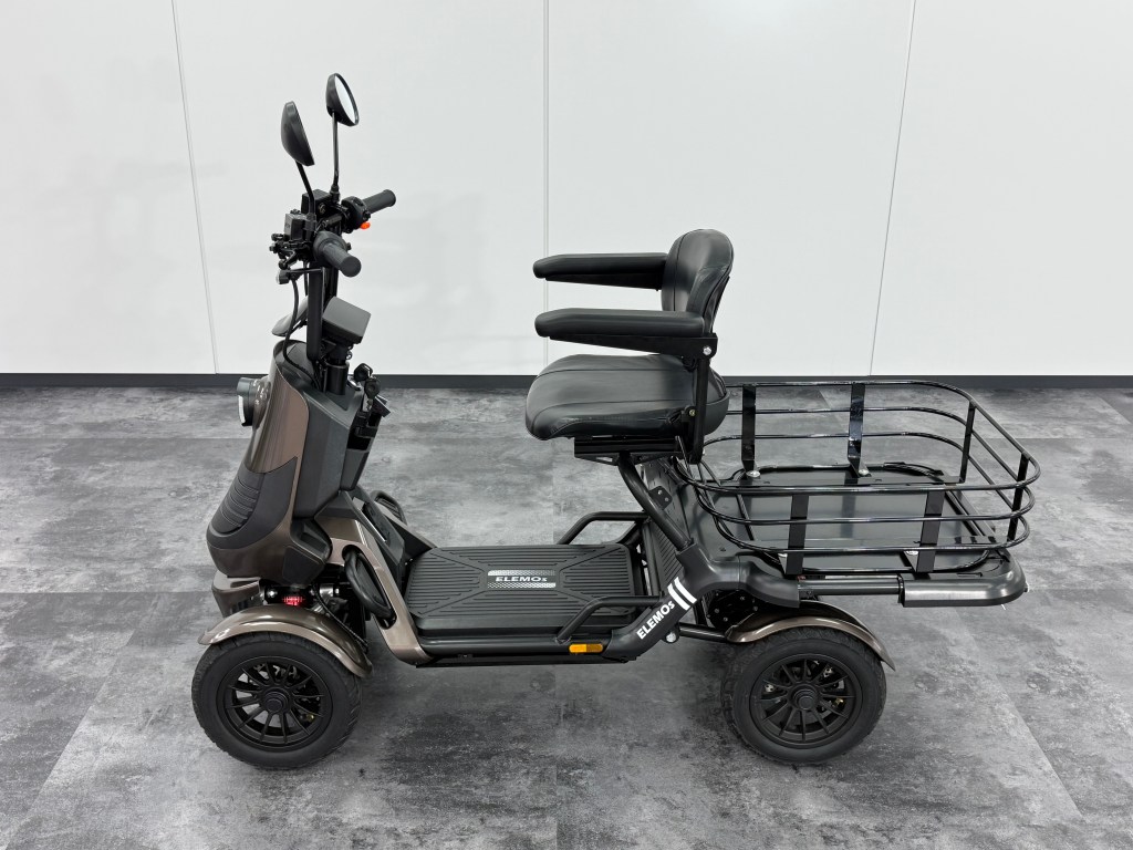 ELEGRAN F-class PREMIUM エレグラン エフクラス プレミアムサイドビュー | ELEMOs Electric mobility scooter with padded seat and rear cargo rack parked indoors on gray tile floor.